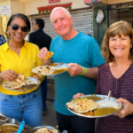 Street Food in Delhi: Go with Harry on Old Delhi's Best Food Tour International guests enjoying a Delhi Street Food Tour with Harry while tasting authentic parathas in Chandni Chowk, Old Delhi.