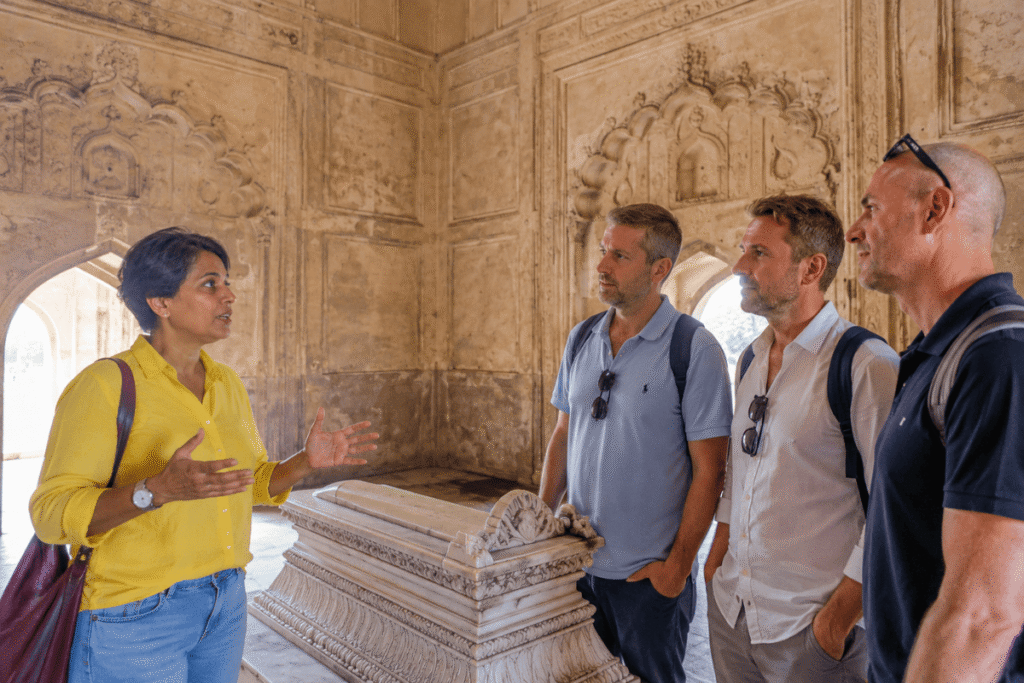 Harry, a licensed Safdarjung Tomb tour guide, explaining the history of Safdarjung Tomb beside the marble cenotaph inside the mausoleum in Delhi.
