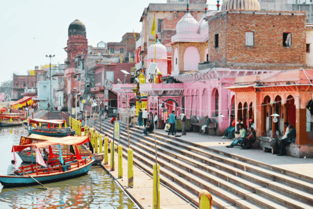 Harry, the Mathura Vrindavan tour guide, relaxing with her guests during a serene boat ride at Vishram Ghat, immersing in the peaceful ambiance of the Yamuna River