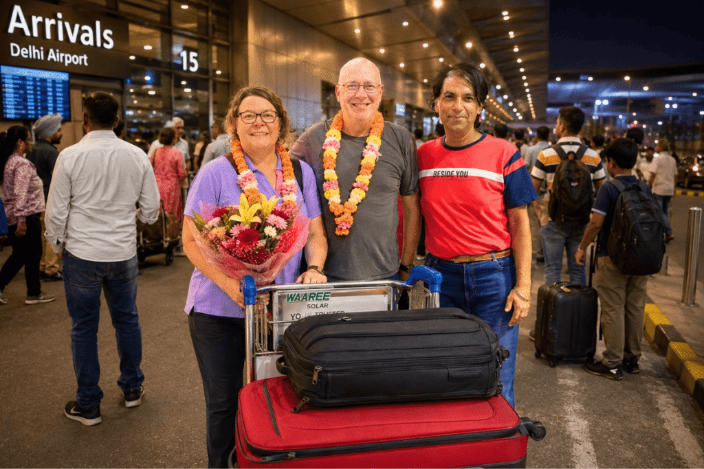 Australian tourists Sarah and Brad receiving fresh marigold garlands from private Delhi tour guide Harry at the airport arrival hall