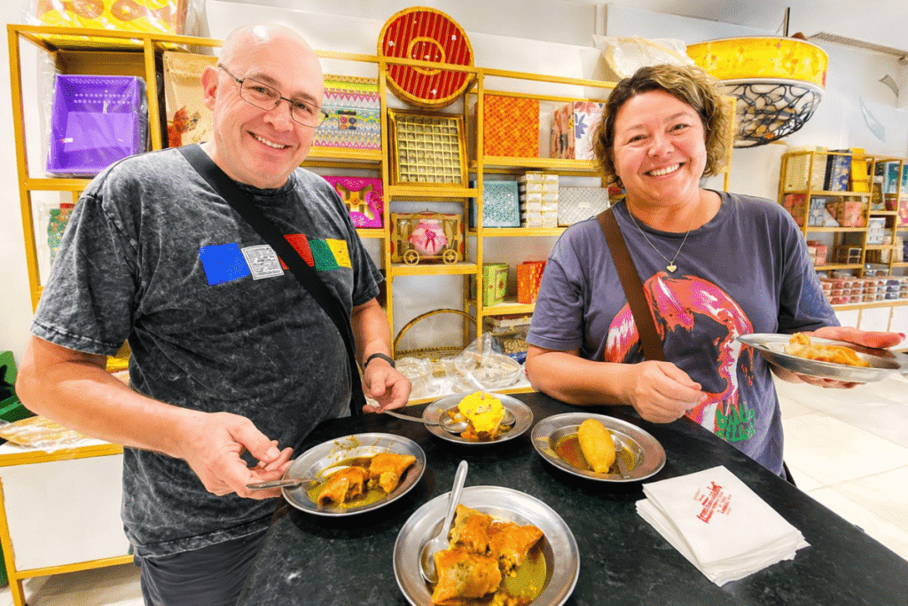 Australian couple Sarah and Brad enjoying an authentic street food tour  with their trusted private tour guide Harry
