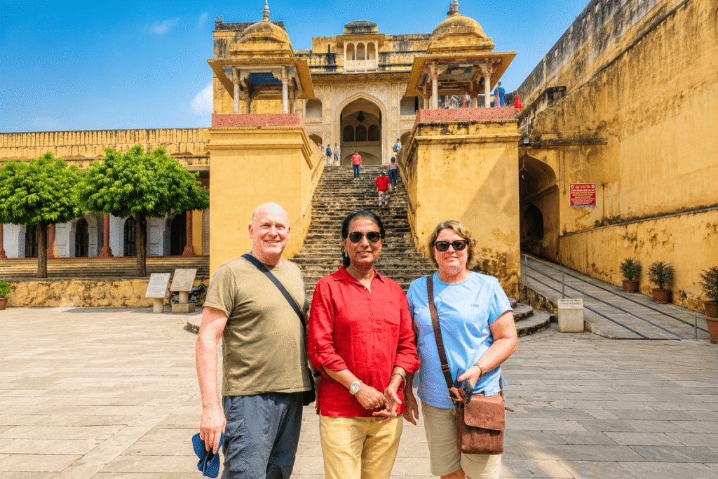 international tourists posing in front of a majestic fort gateway during their custom Delhi Agra Jaipur tour