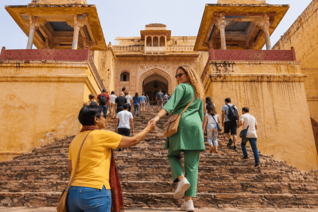 An American solo experiencing Jaleb chowk Singh Pol and crowd at Amber Fort Jaipur with Tour guide in Jaipur