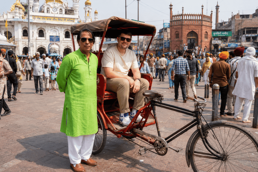 International tourist enjoying a Rikshaw tour with Delhi tour guide at Chandni chowk Old Delhi