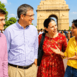 Government-approved Delhi tour guide welcoming international guests during a private Old and New Delhi sightseeing tour at India Gate.