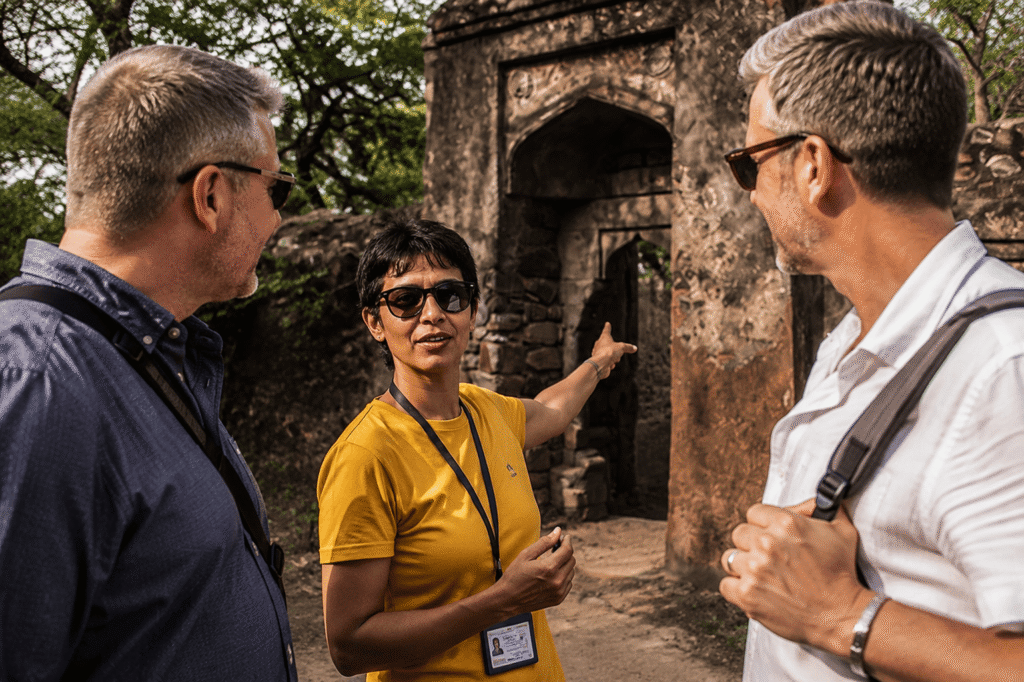Licensed Delhi tour guide guiding travelers through a secret historical monument archway on a private hidden places in Delhi tour